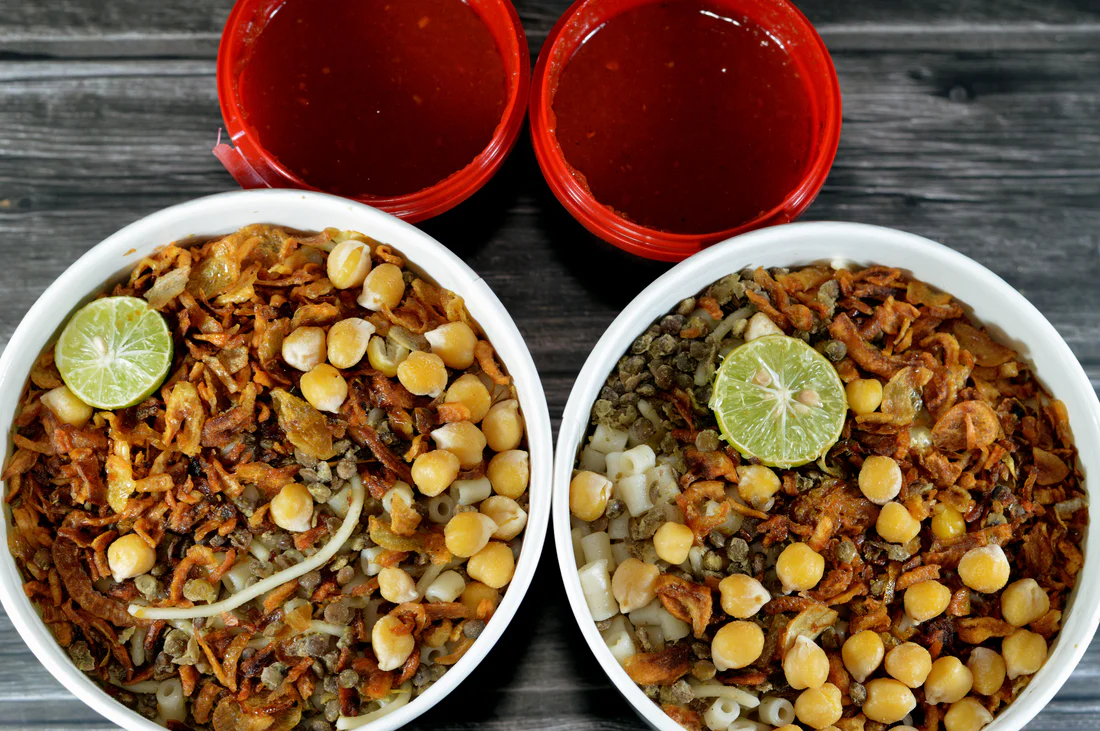 Koshari, Egypt's national dish, with rice, lentils, macaroni, chickpeas, fried onions, and tomato sauce