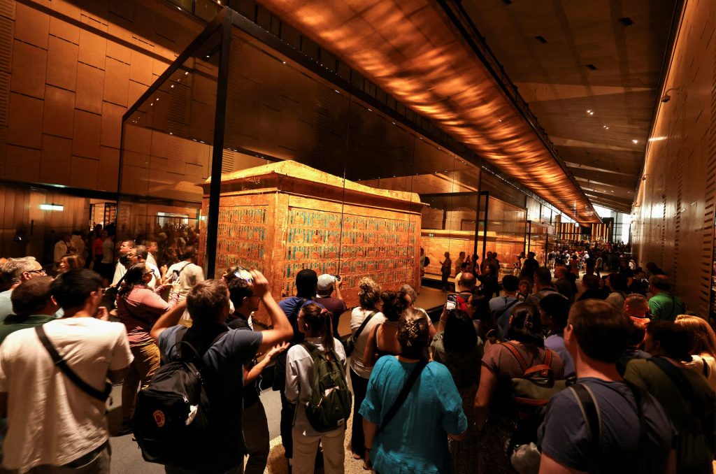 Visitors walk the gallery of ancient Egyptian king Tutankhamun