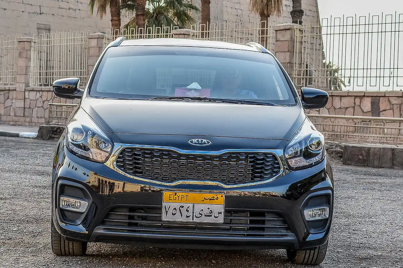 A rental car on the road near Luxor, with the West Bank cliffs in the background