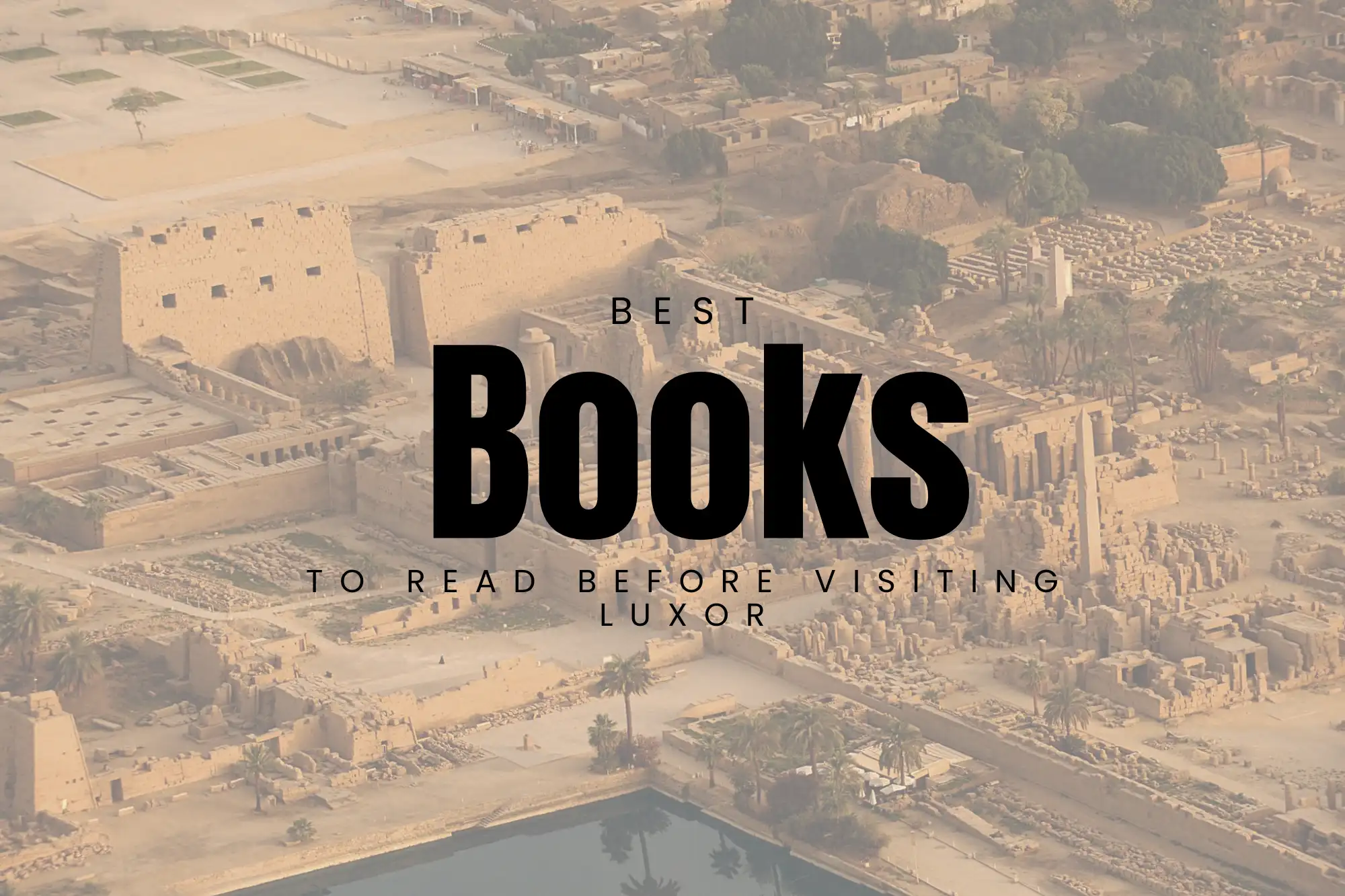 A stack of books about ancient Egypt and Luxor, with the Nile and West Bank cliffs in the background